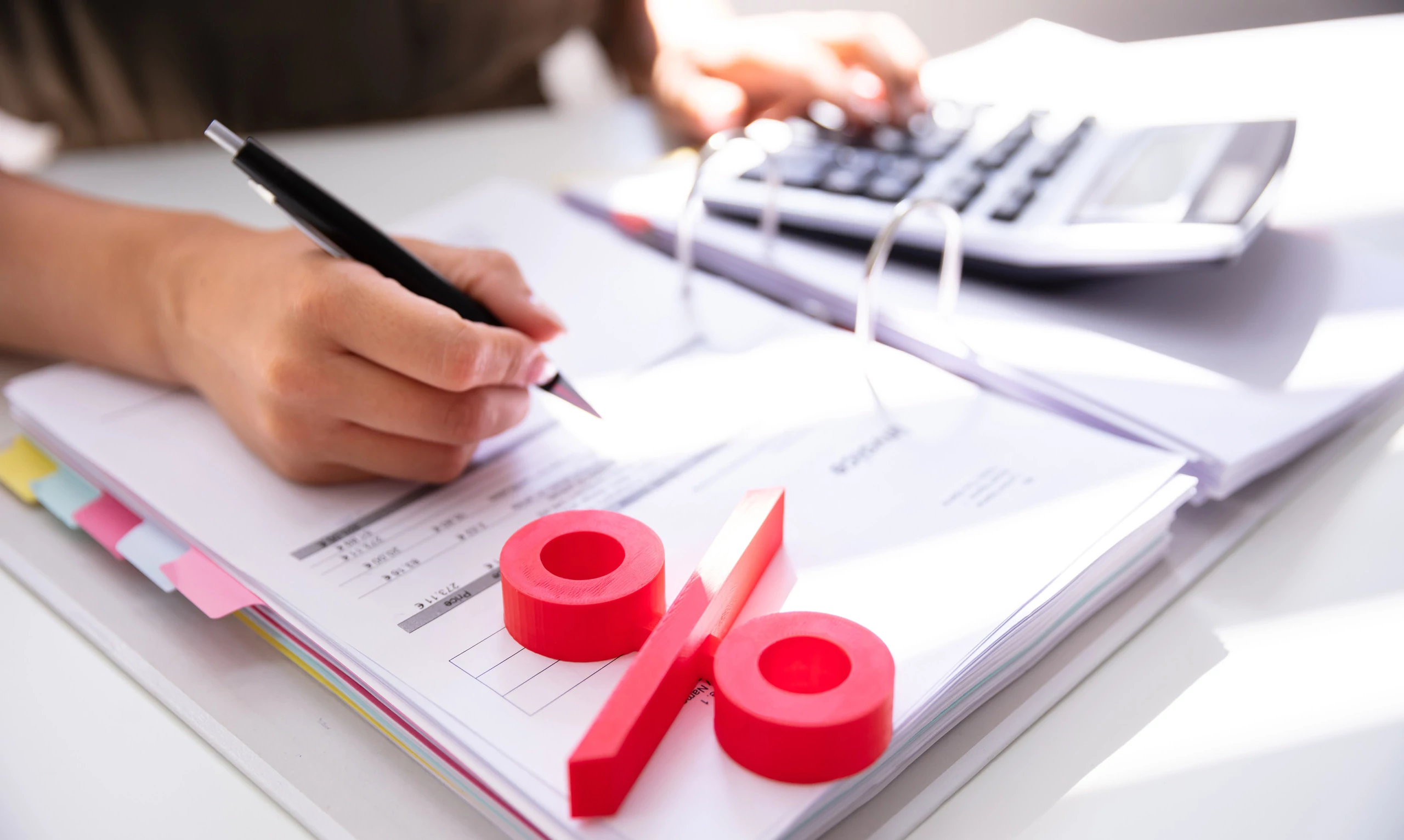 Calcul de la cotisation AVS pour personne sans activité lucrative avec calculatrice, dossier et symbole de pourcentage.